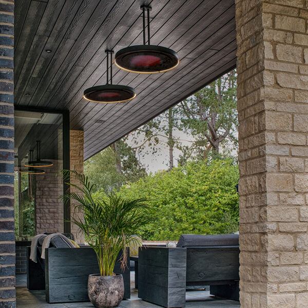 A luxury outdoor living space with Bromic Eclipse pendant style heaters hanging above a seating area.