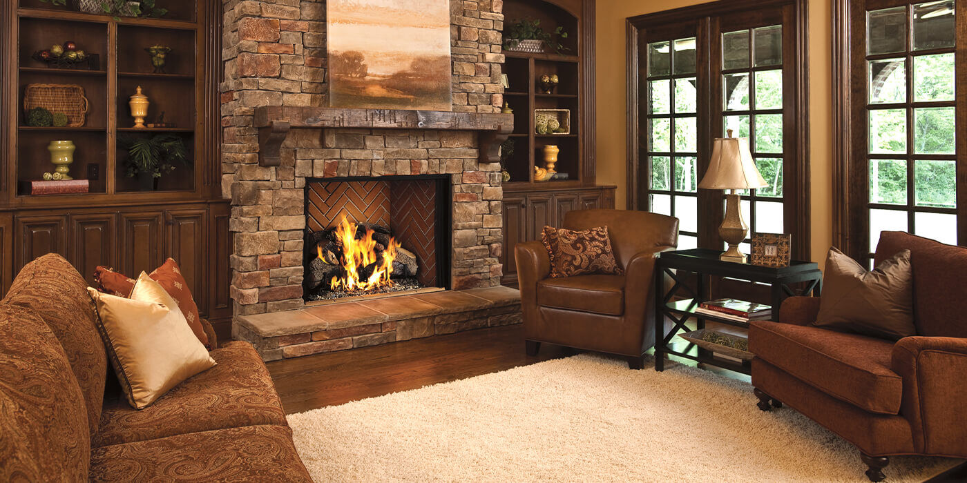 A wood burning fireplace in a residential living space 