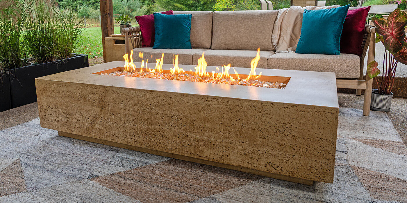 The FlameCraft Tuscan Rectangular Gas Fire Pit installed on an outdoor covered patio