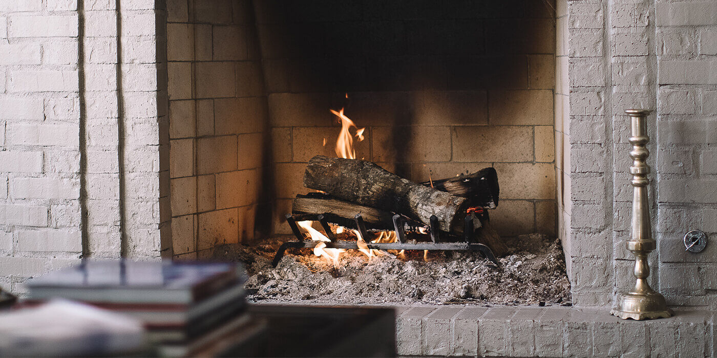 A close-up view of a wood burning fireplace opening