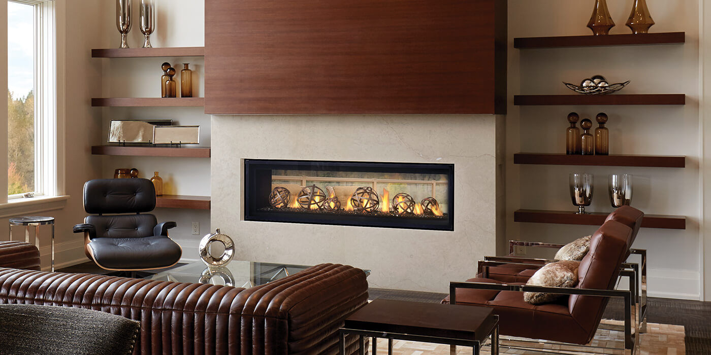 A contemporary linear gas fireplace with decorative metal ornaments in the burning display