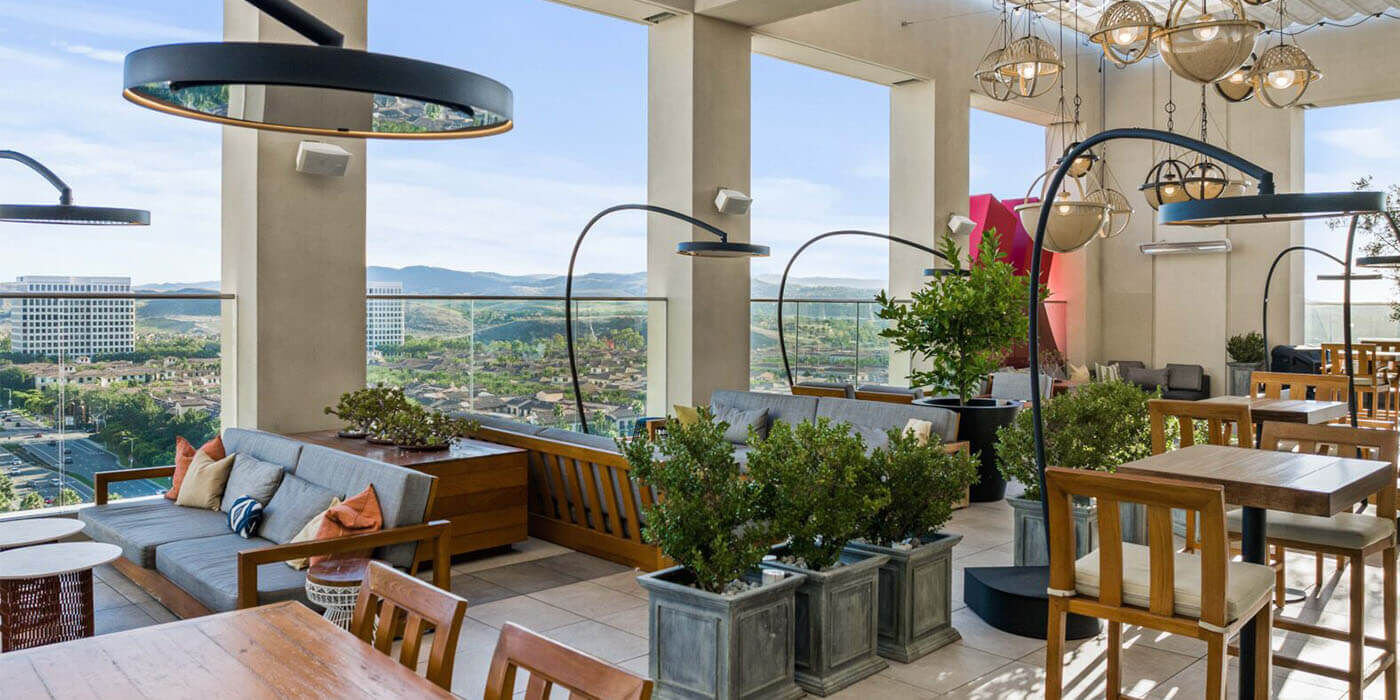 An enclosed restaurant patio space with several Bromic Eclipse freestanding heaters placed around