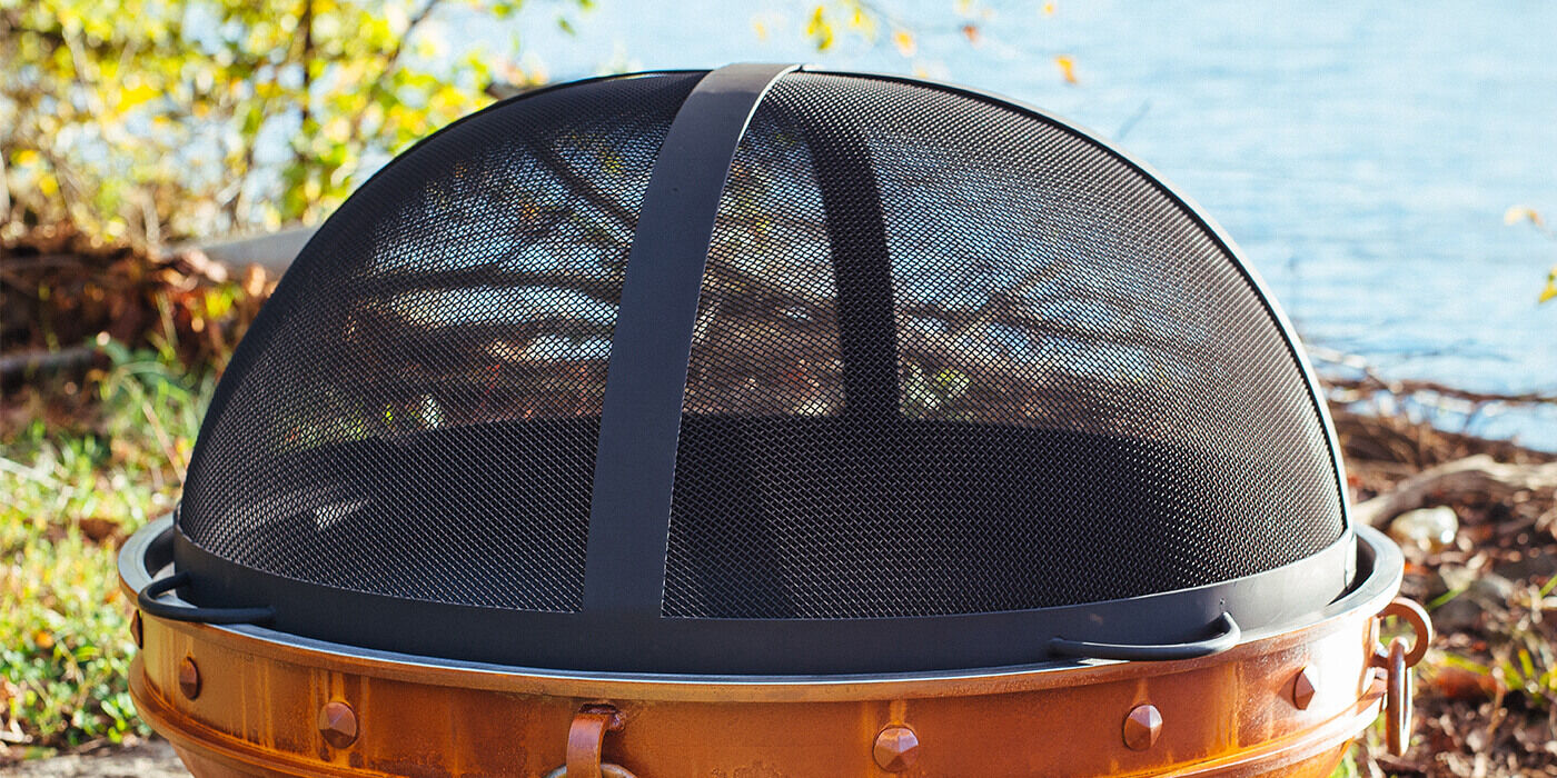 A dome-shaped wood burning fire pit screen