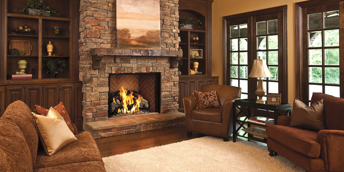 A traditional living space with a classic wood burning fireplace and natural stone hearth 