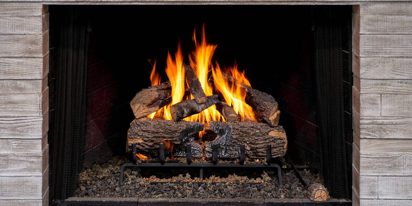 A close-up view of a realistic, rustic Direct Vent gas log set