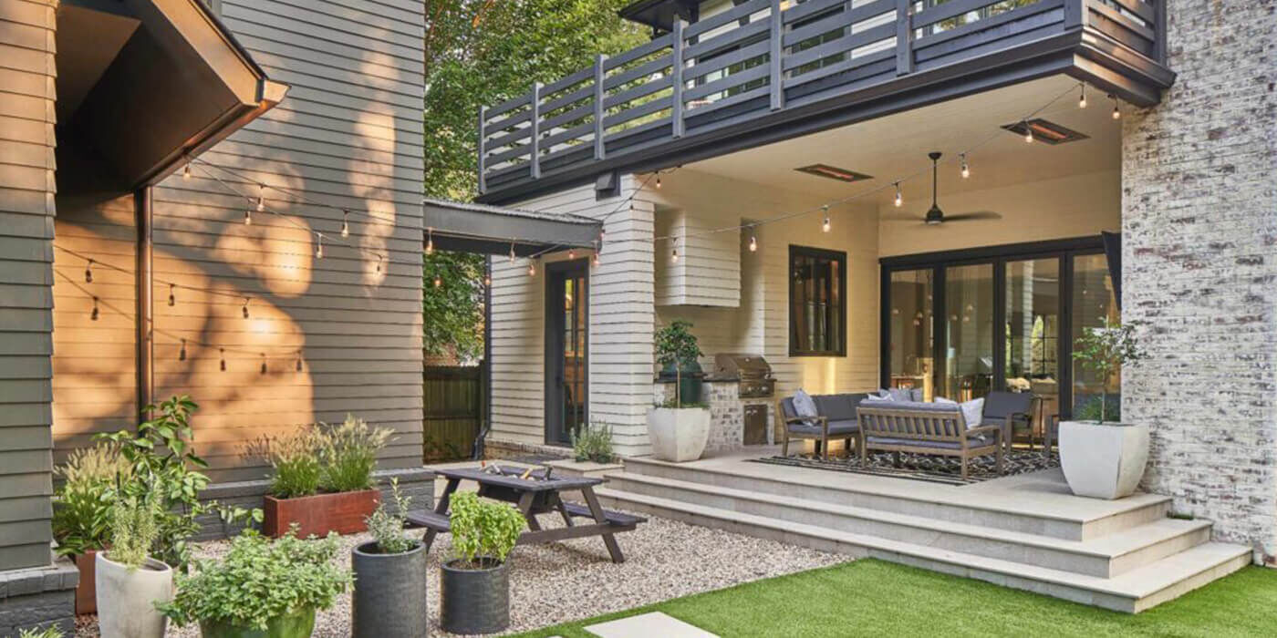 A backyard space with seating areas a covered porch and ceiling-mounted patio heaters from Infratech