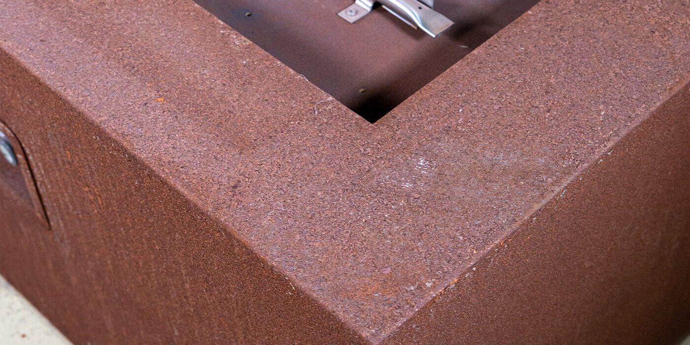 Close-up of a Corten steel gas fire pit