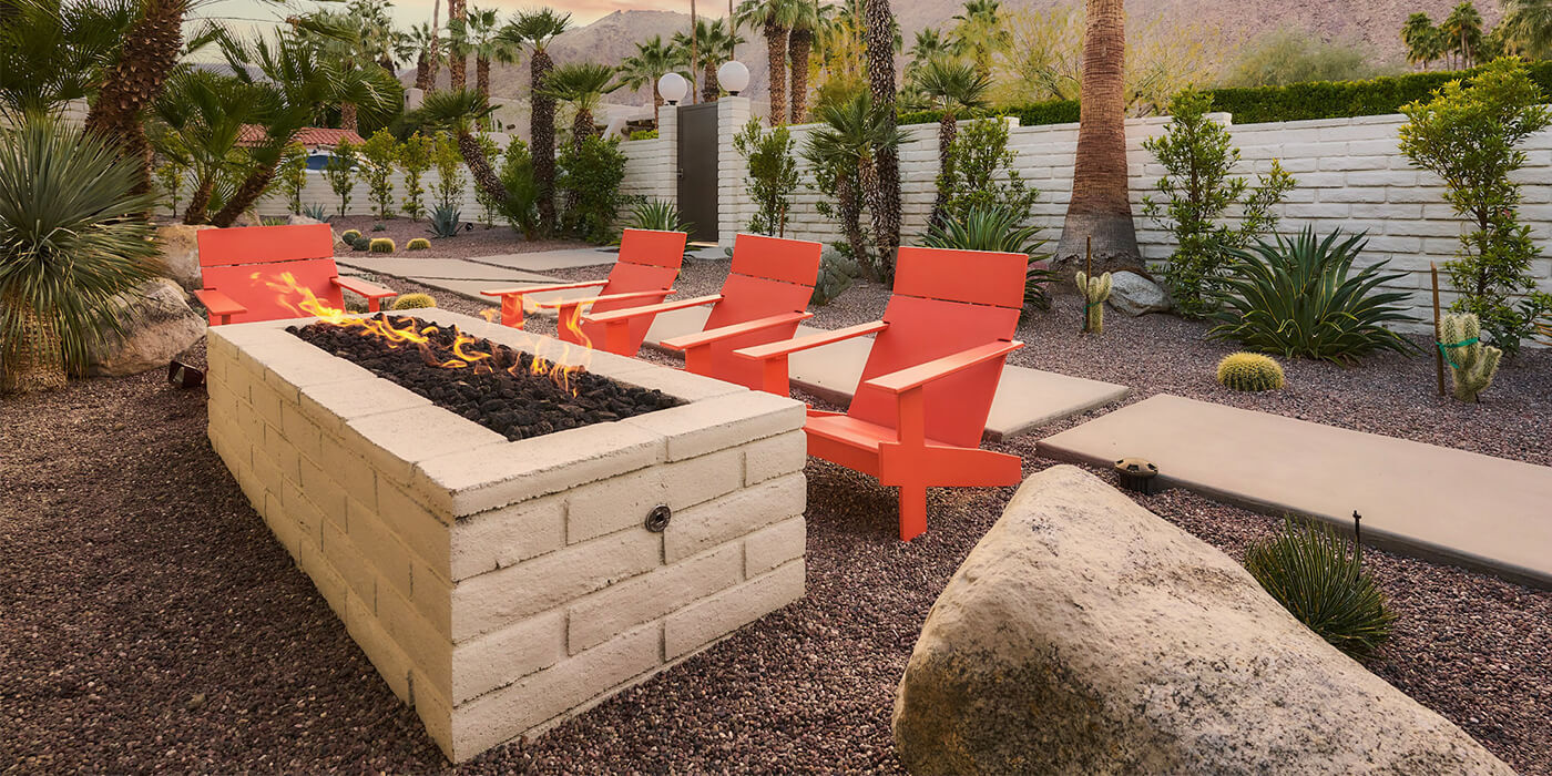 An outdoor space with a custom fire pit area and seating 
