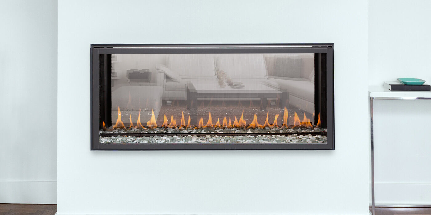 A linear see-through gas fireplace