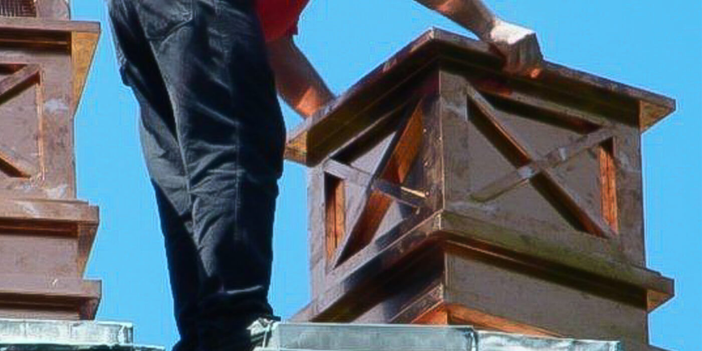 this is a photo of a professional chimney sweep performing a chimney inspection, cleaning, and repair 
