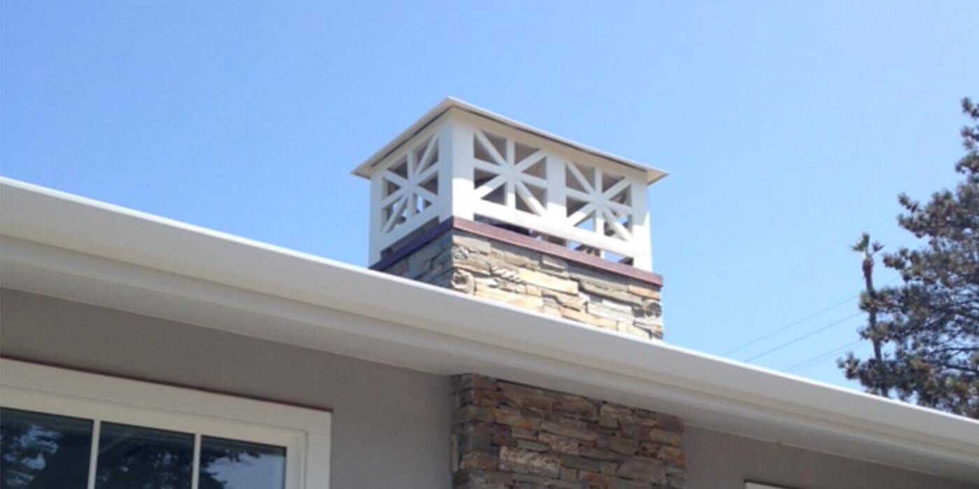 A painted white decorative chimney shroud by the brand American Chimney Shroud