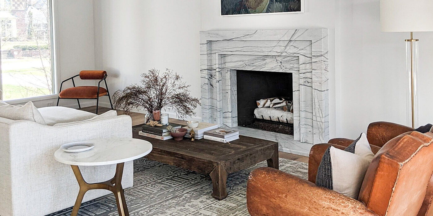 A modern, minimalistic living space with a classic square fireplace and a white Birch style gas log set.