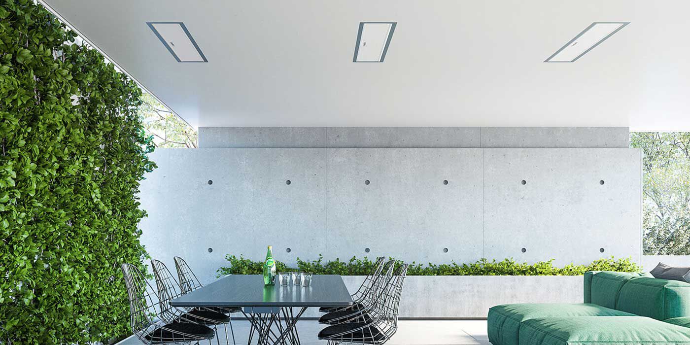 A modern, minimalistic outdoor dining space with a three electric patio heaters recessed into the ceiling