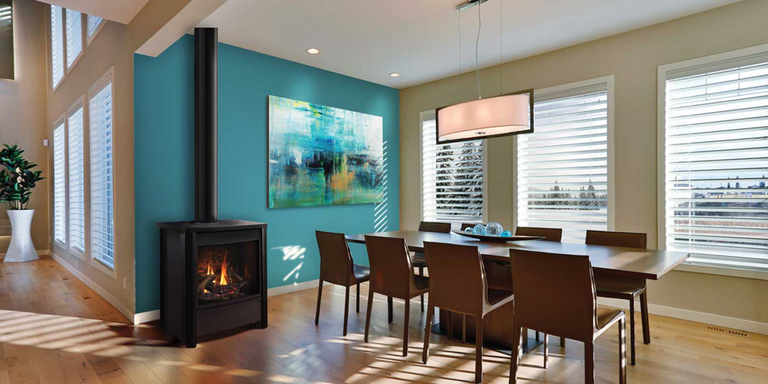 A contemporary dining space with a traditional wood burning stove